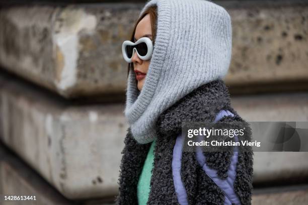 Guest wears grey balaclava, mint green dress, grey teddy coat jacket, outside Cecilie Bahnsen during Paris Fashion Week - Womenswear Spring/Summer...