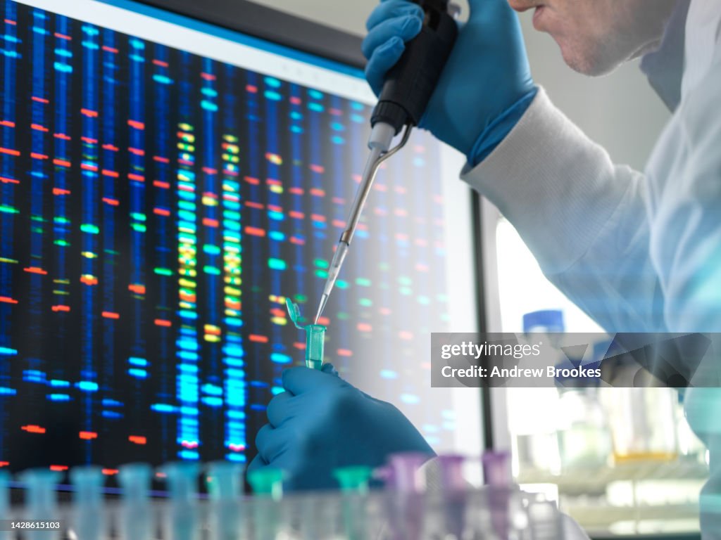 Scientist pipetting a DNA sample into a vial ready for testing