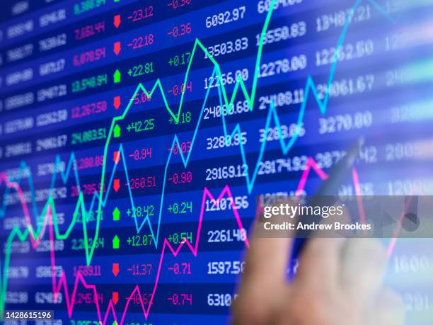 stock trader viewing performance of shares on screen - stock market traders stock pictures, royalty-free photos & images