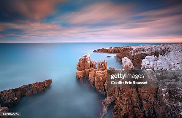 rocks in sea at sunset - antibes ストックフォトと画像