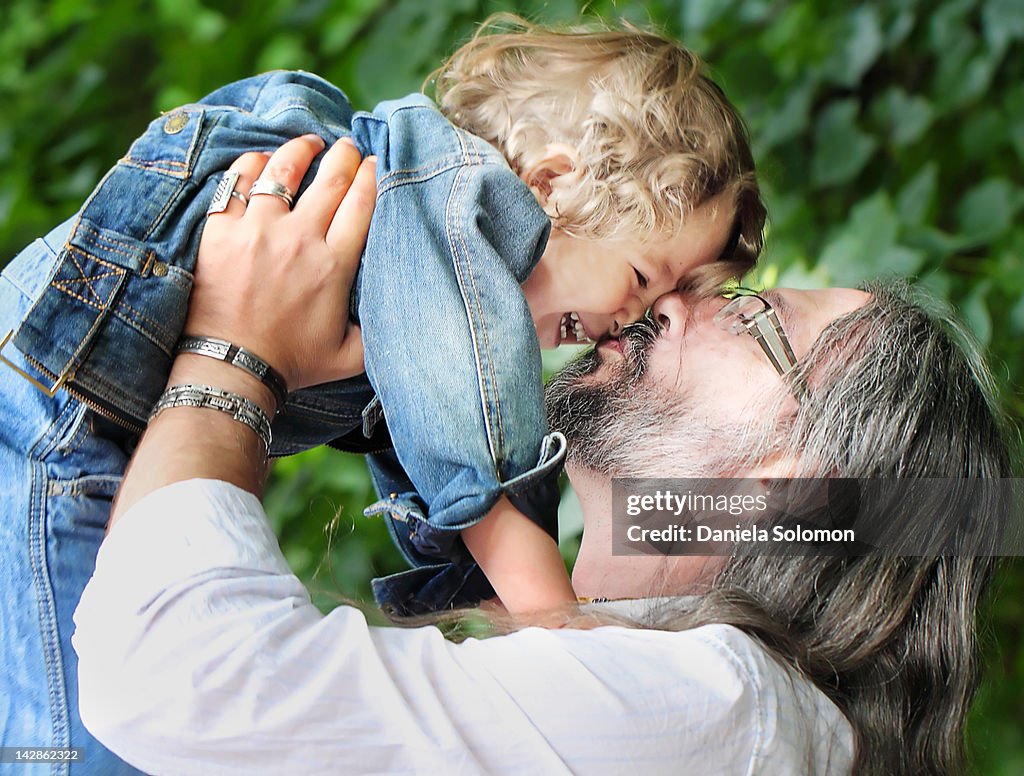 Father kissing and holding his son