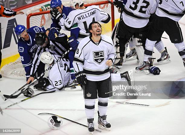 Drew Doughty of the Los Angeles Kings laughs as he watches the brawl behind him on the jumbotron during the game against the Vancouver Canucks in...