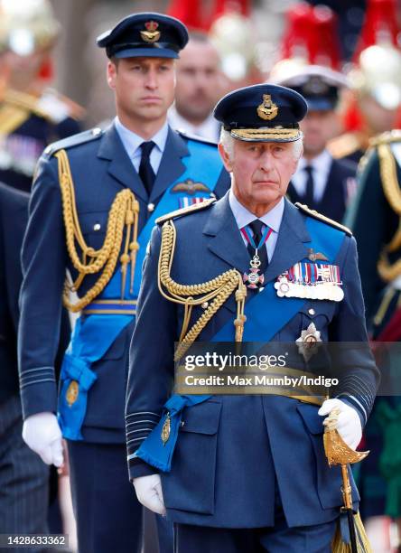 Prince William, Prince of Wales and King Charles III walk behind Queen Elizabeth II's coffin as it is transported on a gun carriage from Buckingham...