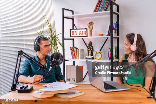 interview and discussion between a blogger and a guest on a live podcast show - radio presenters stock pictures, royalty-free photos & images