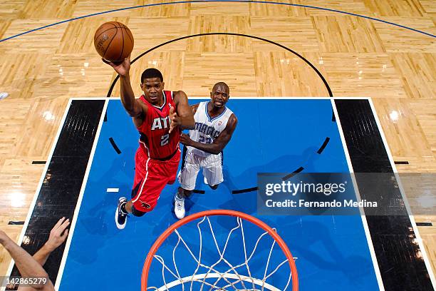 Joe Johnson of the Atlanta Hawks shoots against Jason Richardson of the Orlando Magic on April 13, 2012 at Amway Center in Orlando, Florida. NOTE TO...