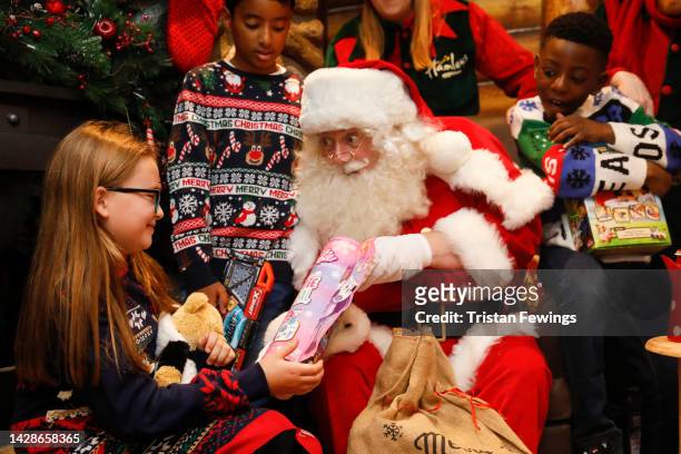 Santa with children in the grotto as Hamleys unveil their Top Ten Toys for Christmas, on September 29, 2022 in London, England.