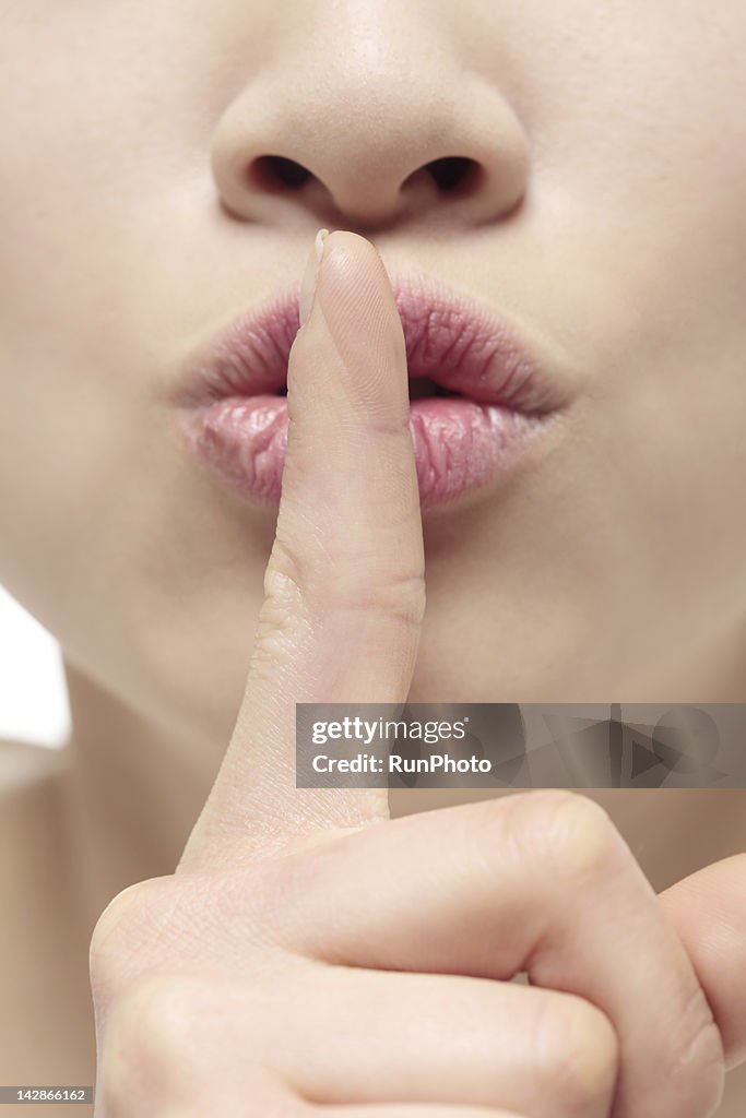Woman with finger to lips,close-up