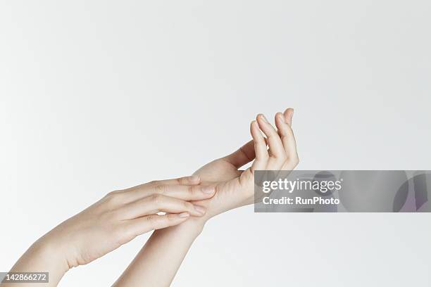 woman's hand - rubbing hands together stock pictures, royalty-free photos & images