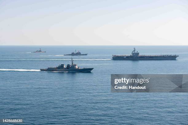 In this handout image provided by the South Korean Defense Ministry, The U.S. Nuclear-powered aircraft carrier Ronald Reagan and South Korean...
