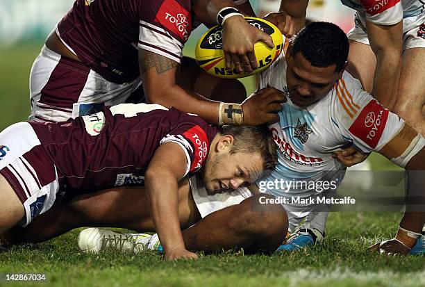 Tauryn Laurenson of the Titens is tackled by Pat Murphy of the Sea Eagles during the round seven Toyota Cup match between the Manly Sea Eagles and...