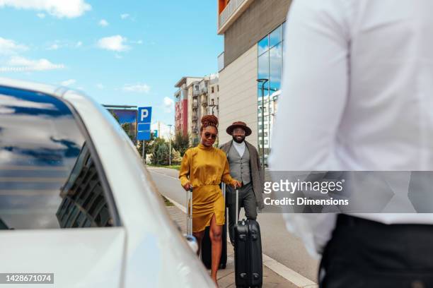 wealthy couple picked up at airport. - chauffeurs stock pictures, royalty-free photos & images