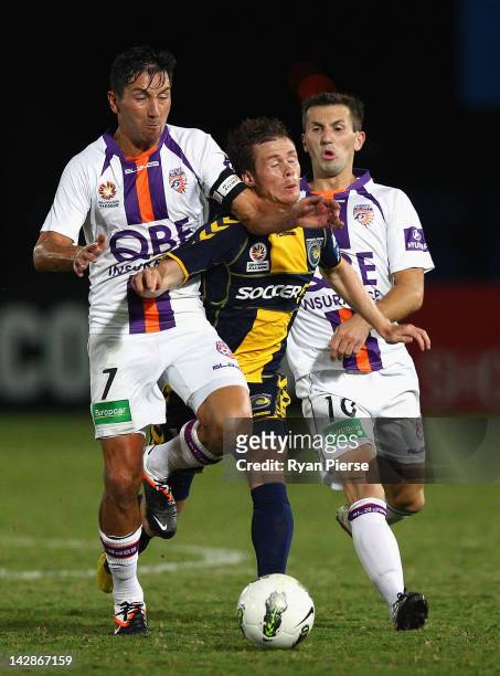 Michael McGlinchey of the Marinersis tackled by Jacob Burns of the Glory during the A-League Grand Final Qualifier match at Bluetongue Stadium on...