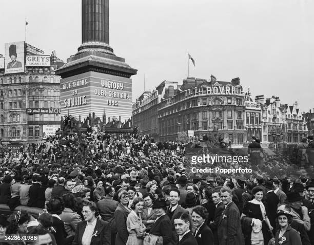 Large crowds gather in Trafalgar Square to listen to a broadcast by Prime Minister Winston Churchill as they celebrate Victory in Europe Day to mark...