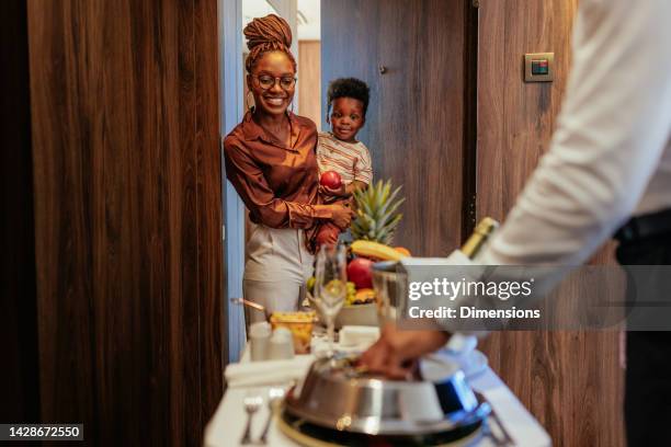 wealthy hotel guest receiving room service. - serviços de limpeza imagens e fotografias de stock