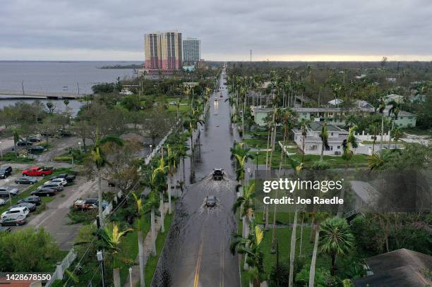 In this aerial view, vehicles make their way through a flooded area after Hurricane Ian passed through the area on September 29, 2022 in Fort Myers,...