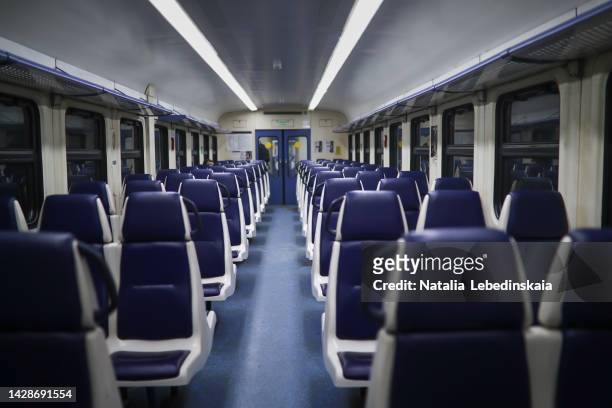 blue seats in an empty train car. traveling by modern intercity train - treincoupé stockfoto's en -beelden