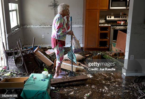 Stedi Scuderi looks over her apartment after flood water inundated it when Hurricane Ian passed through the area on September 29, 2022 in Fort Myers,...