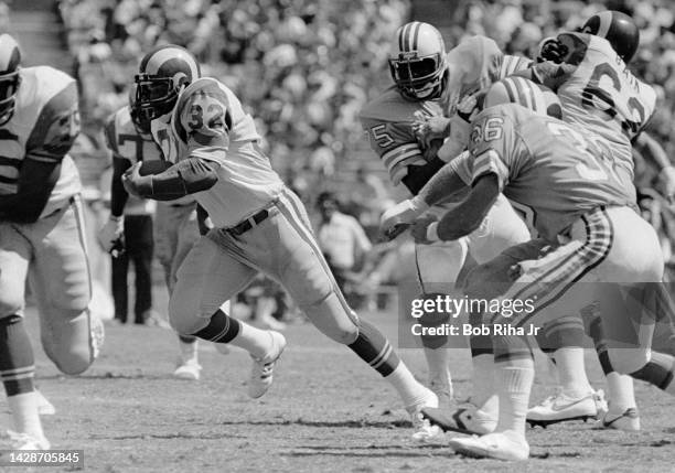 Los Angeles Rams RB Cullen Bryant sprints past Houston Oilers Gregg Bingham and Carter Hartwig during game action, September 6, 1981 in Anaheim,...