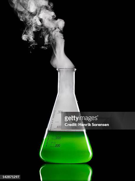 smoke emitting from laboratory flask - lab flask imagens e fotografias de stock