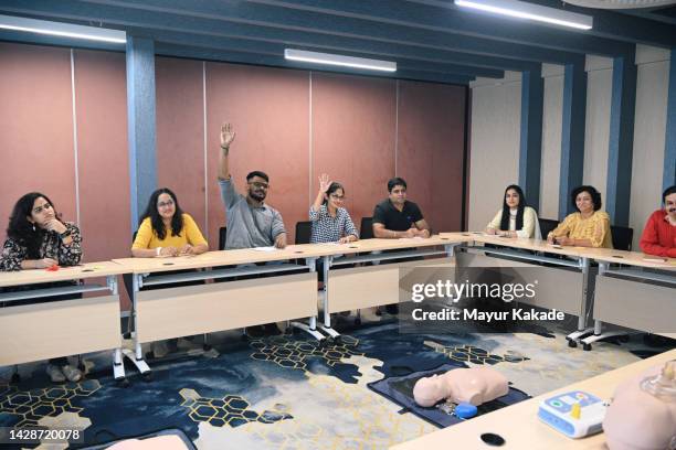 adult learners asking questions during first aid cpr training - gesturing stock pictures, royalty-free photos & images