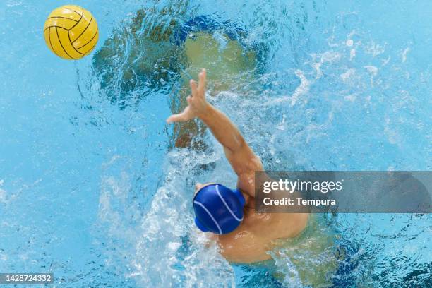 men professional water polo reaching for the ball. - fault sports stock pictures, royalty-free photos & images