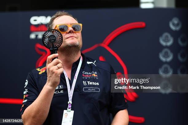 Alan Carr tries to cool off with a fan while wearing Red Bull Racing team kit during previews ahead of the F1 Grand Prix of Singapore at Marina Bay...