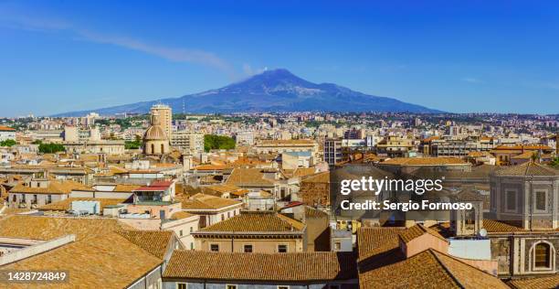 panoramic of mt etna volcano over catania city, sicily, italy - catania stock-fotos und bilder