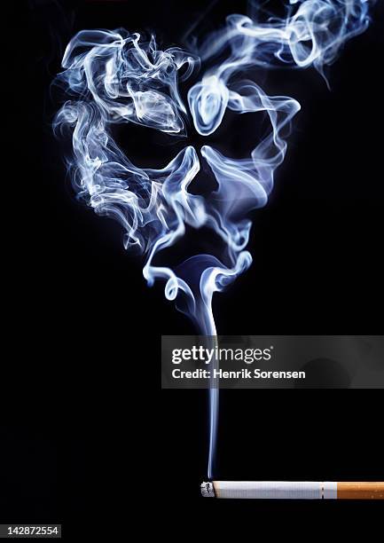 smoke from cigarette formed like cranium - smoker skull stock pictures, royalty-free photos & images