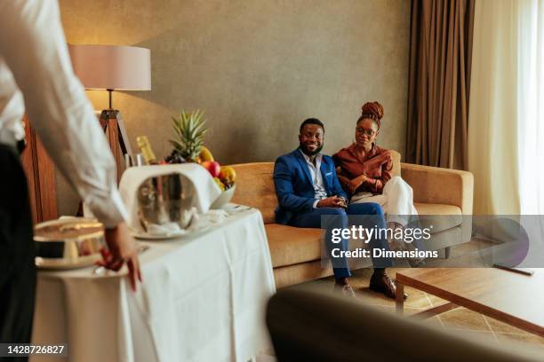 wealthy couple catered with room service - room service stock pictures, royalty-free photos & images