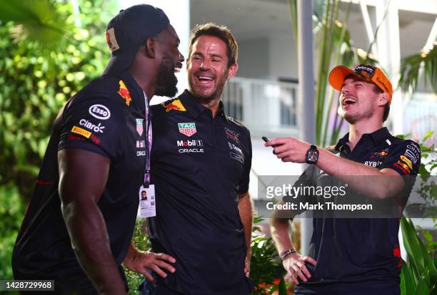 Max Verstappen of the Netherlands and Oracle Red Bull Racing shares a joke with Micah Richards and Jamie Redknapp in the Paddock during previews...