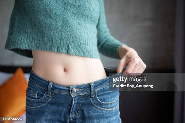 cropped shot of slim woman while wearing jeans. - skinny trousers stock pictures, royalty-free photos & images