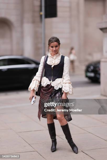 Fashion week guest seen wearing a beige / brown look, outside Halpern Show during London Fashion Week, on September 18, 2022 in London, England.