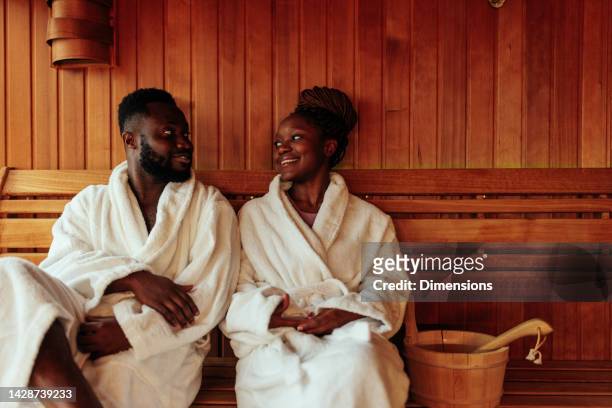 happy african american couples in sauna. - sauna wellness stock pictures, royalty-free photos & images