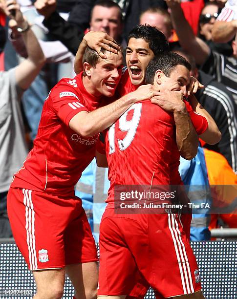 Luis Suarez of Liverpool celebrates scoring the equalising goal with team mates Jordan Henderson and Stewart Downing during the FA Cup with Budweiser...