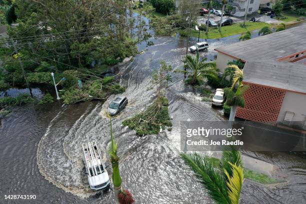 In this aerial view, vehicles make their way through a flooded area after Hurricane Ian passed through on September 29, 2022 in Fort Myers, Florida....