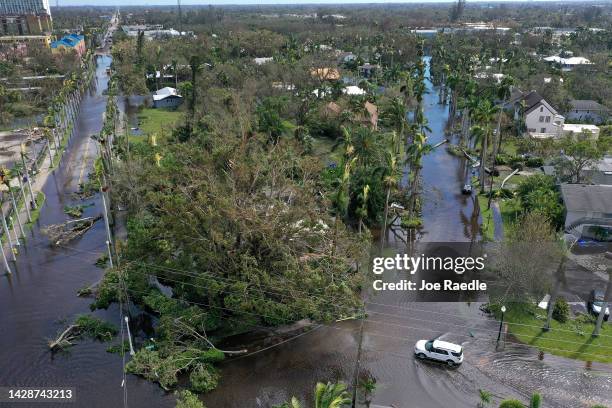 In this aerial view, vehicles make their way through a flooded area after Hurricane Ian passed through on September 29, 2022 in Fort Myers, Florida....