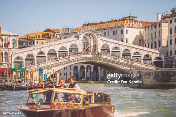 tourists enjoying water taxi services in venice - táxi aquático imagens e fotografias de stock