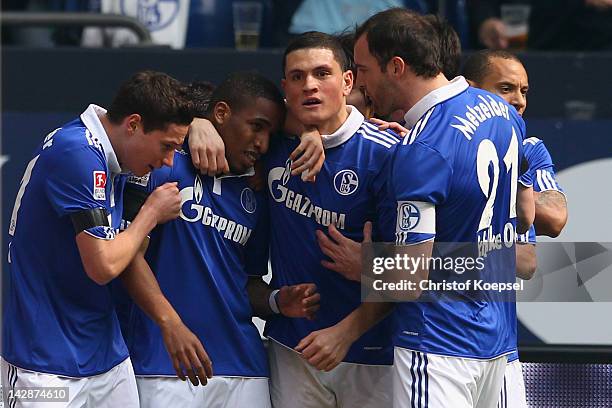 Jefferson Farfan of Schalke celebrates the first goal with Julnian Draxler , Kyriakos Papadopoulos and Christoph Metzelder of Schalke during the...