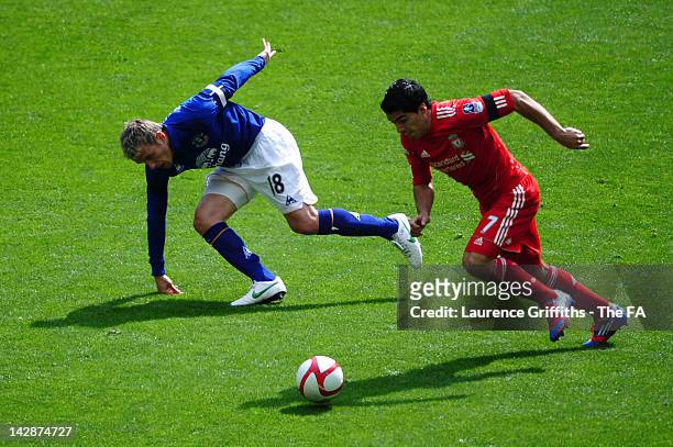 Phil Neville of Everton and Luis Suarez of Liverpool battle for the ball during the FA Cup with Budweiser Semi Final match between Liverpool and...