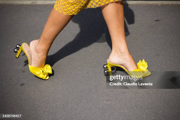 Thassia Naves is seen wearing yellow shiny satin heels outside the Gucci show during the Milan Fashion Week - Womenswear Spring/Summer 2023 on...
