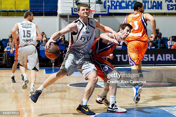 Arturas Jomantas, #21 of Lietuvos Rytas competes with Victor Claver, #9 of Valencia Basket during the semifinal A of 2012 Eurocup Finals between...