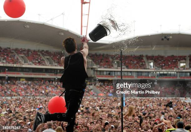 Jared Leto of 30 Seconds to Mars throws a bucket of water into the crowd while performing on stage at The Soundwave Music Festival at Olympic Park on...