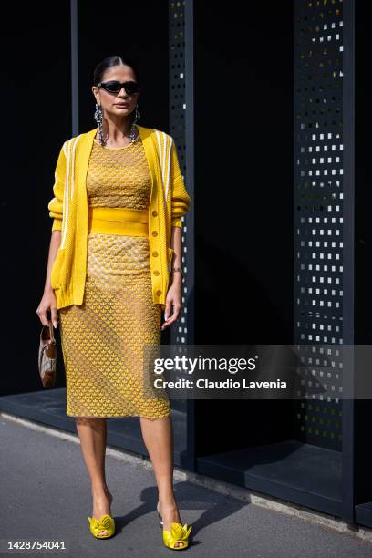 Thassia Naves is seen wearing a black Gucci sunglasses, transparent tulle top and skirt from Gucci x Adidas, a yellow and white print pattern wool...