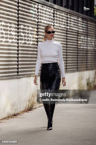 Chiara Ferragni wearing a white turtle neck top, black leather skirt, and black long leather boots outside Courreges, during Paris Fashion Week -...