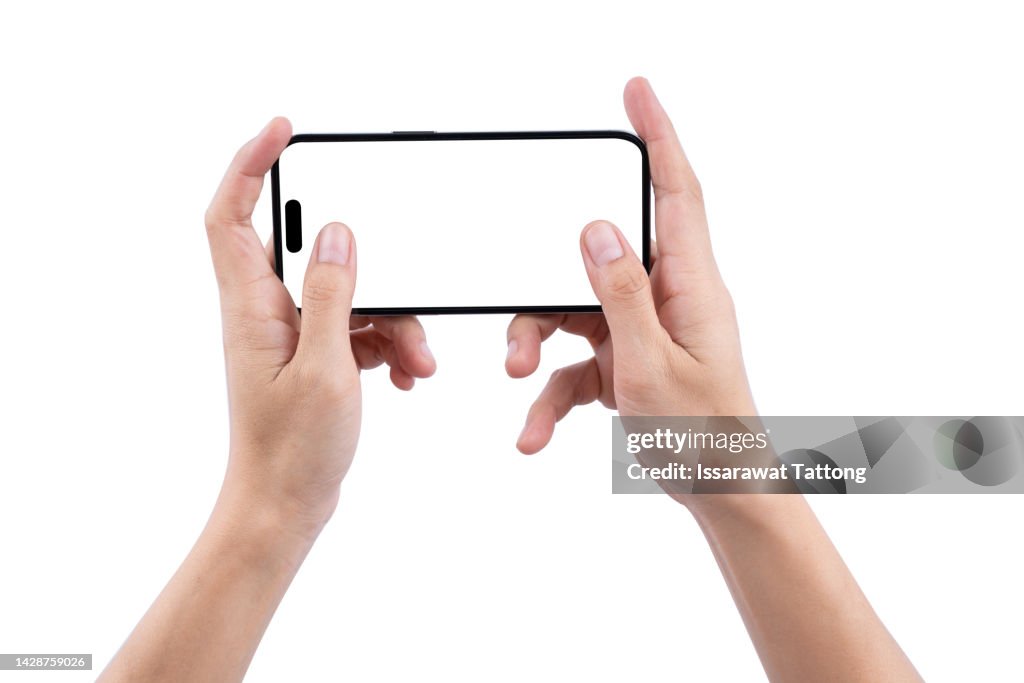 Female's Hands Playing on Smartphone Isolated on White Background. Hands of woman Holds a Black Smartphone and Play a Game. Horizontal Position. Screen Blank. Close-Up.