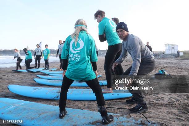 Kelly Slater of the United States interacts with students of the Blown Away Surf School on Day One of the Alfred Dunhill Links Championship at West...