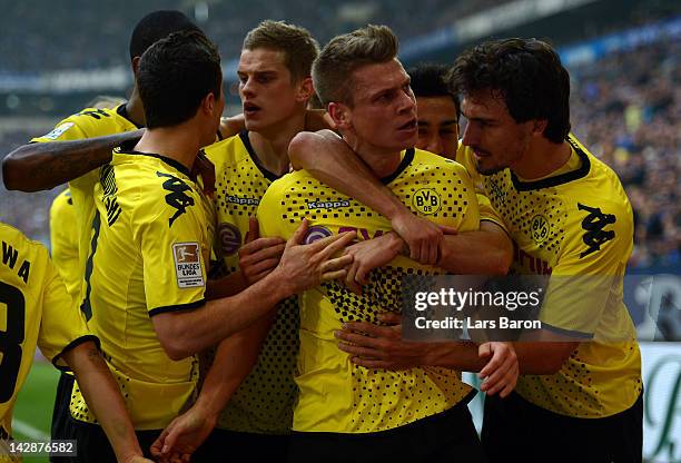 Lukasz Piszczek of Dortmund celebrates with team mates after scoring his teams first goal during the Bundesliga match between FC Schalke 04 and...