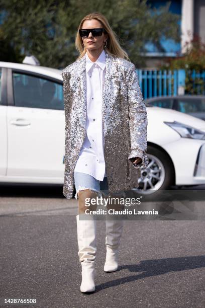 Elizabeth Sulcer is seen wearing silver oversized blazer, white shirt and denim short pants outside the Etro show during the Milan Fashion Week -...