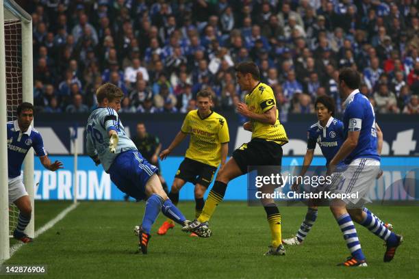 Sebastian Kehl of Dortmund scores the second goal against Lars Unnerstall of Schalke during the Bundesliga match between FC Schalke 04 and Borussia...