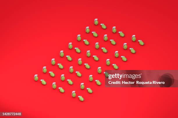 3d render of green hand grenade on red background,conflict and war concept - terrorism icon stock pictures, royalty-free photos & images